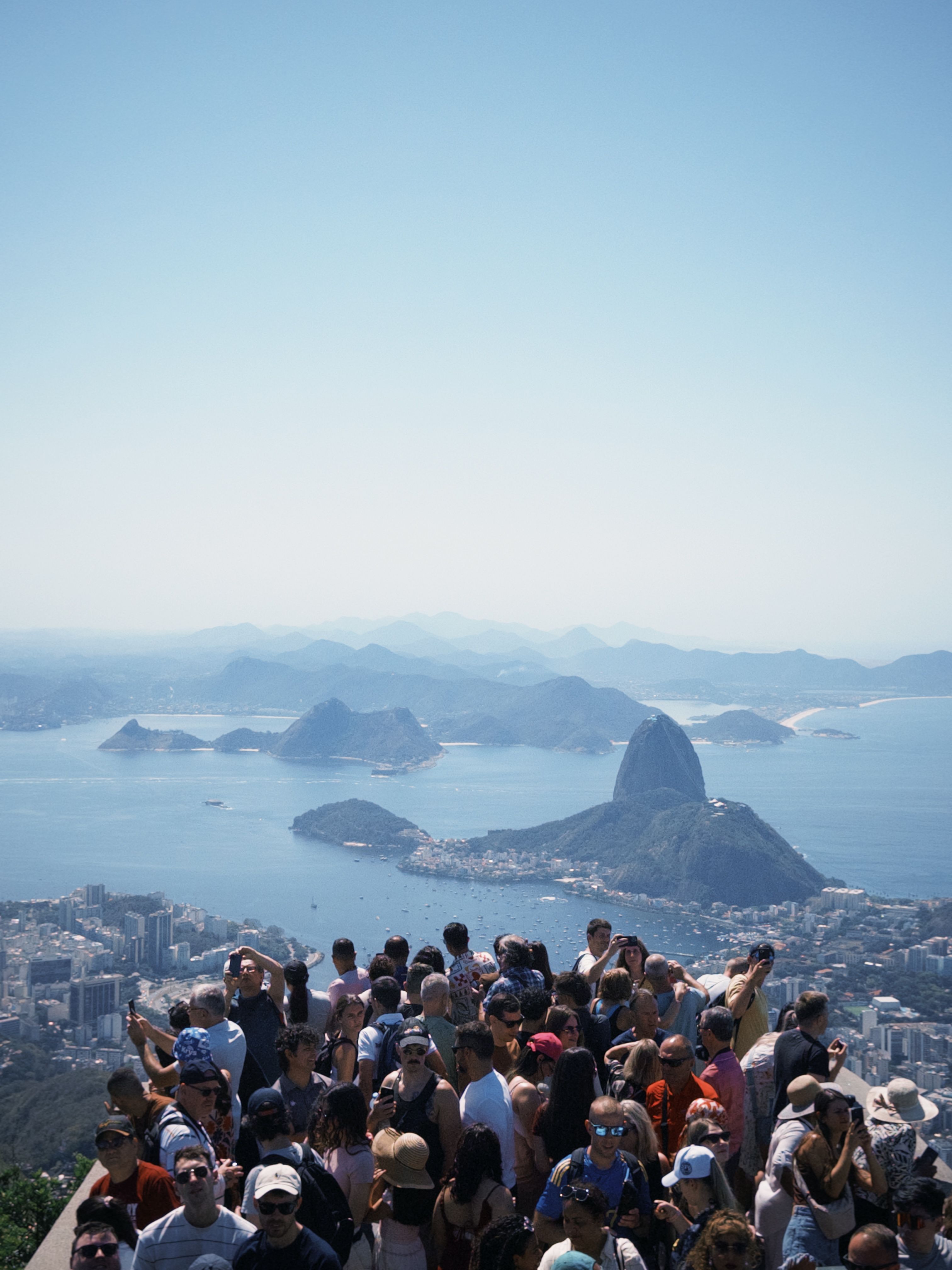 Una folla di visitatori osserva una città e il mare dall'alto
